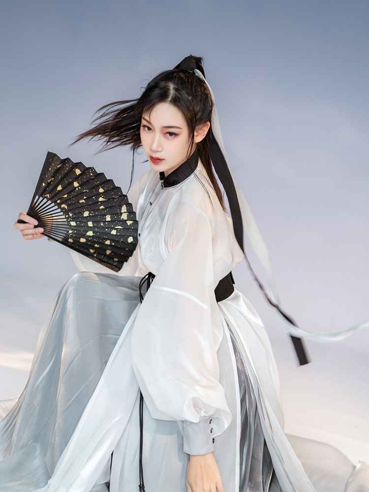 White Featuring a diverse collection of Hanfu styles, this display presents a blend of traditional and modern elements, from the intricate embroidery of classic Hanfu to contemporary menswear. The assortment includes authentic Tang Dynasty dresses and detailed Ming Dynasty Hanfu, alongside luxurious royal attire and scholar officials' outfits. With a special emphasis on men's Hanfu, the exhibit highlights the rich cultural tapestry of traditional Asian clothing and modern, Asian-inspired fashion