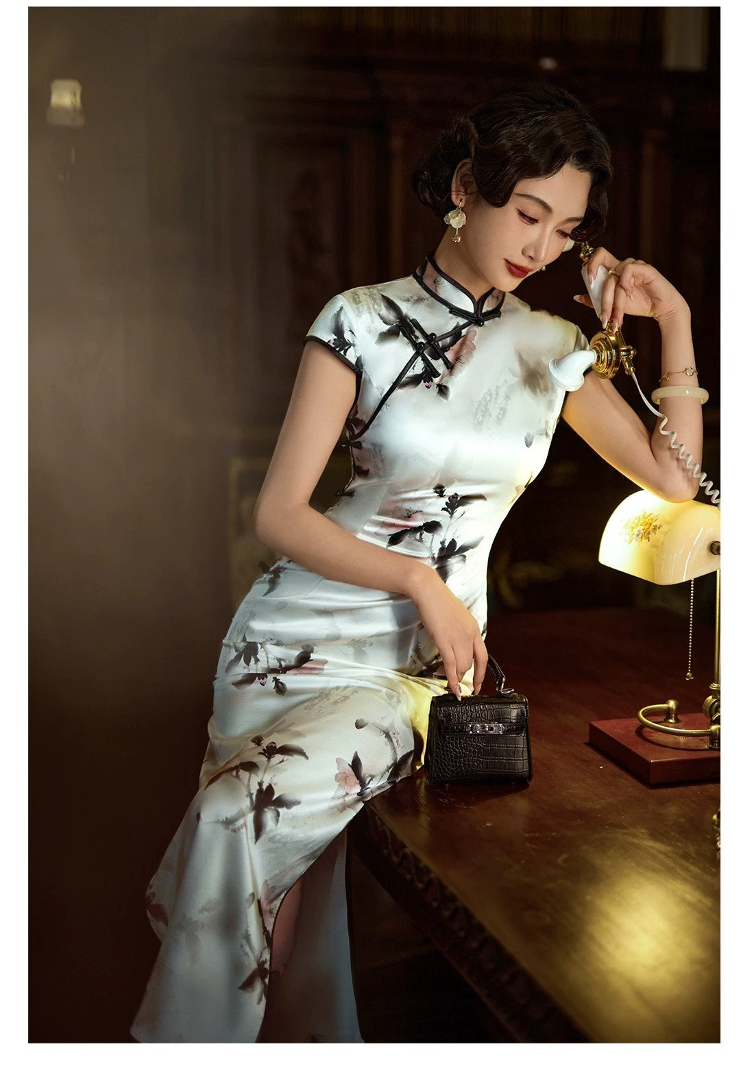 White plum blossom qipao showing a standing collar and fitted dress silhouette