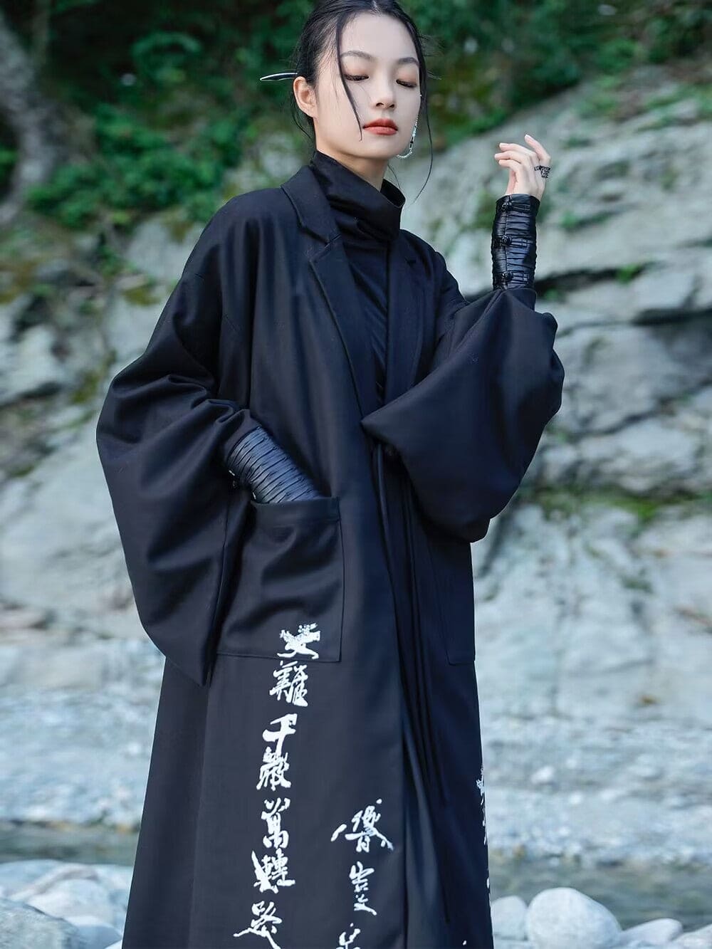 Modern Chinese clothes featuring a black hanfu coat for men, a blend of traditional hanfu menswear and Tang dynasty clothing with a modernized hanfu style, suitable for casual wear or winter hanfu style. The male model is also wearing Chinese cloak and hanfu with pants, depicting a Chinese warrior outfit. The photo indicates where to buy hanfu, including hanfu Amazon and oriental clothing stores near you