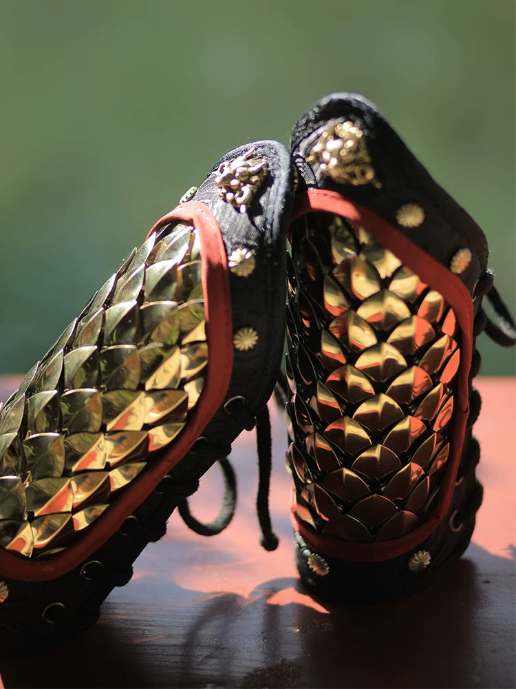 Gold 304 stainless steel dragon-scale Hanfu arm guards shown as a matching lace-up pair