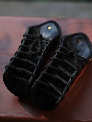 Close view of polished silver overlapping metal scales and black microfiber leather backing