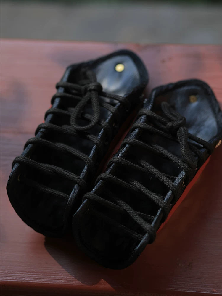 Close view of polished silver overlapping metal scales and black microfiber leather backing