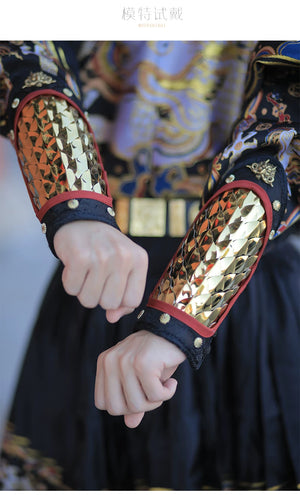 Male model displaying a gold dragon-scale Hanfu arm guard and brass decorative details