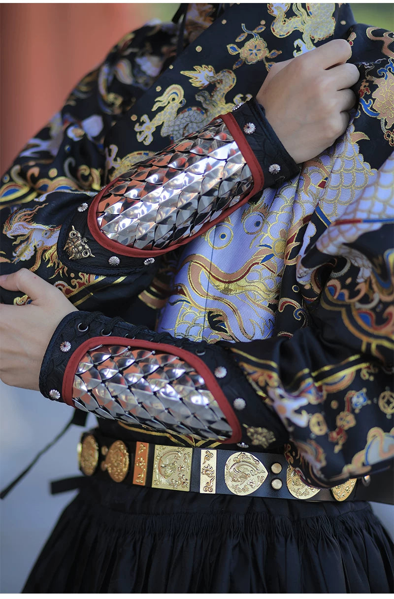 Male model wearing silver stainless steel scale arm guards with adjustable black laces