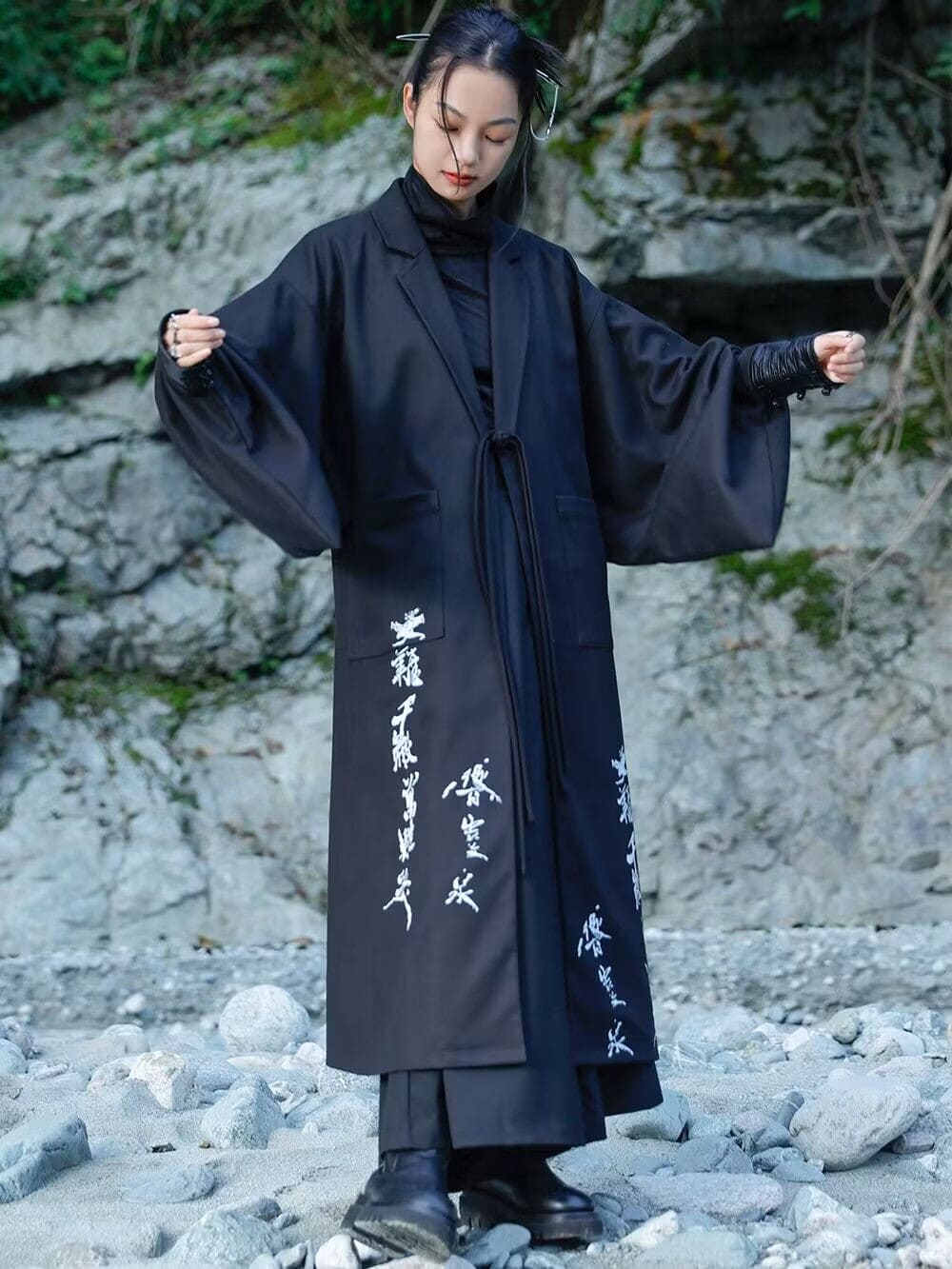 Modern Chinese clothes featuring a black hanfu coat for men, a blend of traditional hanfu menswear and Tang dynasty clothing with a modernized hanfu style, suitable for casual wear or winter hanfu style. The male model is also wearing Chinese cloak and hanfu with pants, depicting a Chinese warrior outfit. The photo indicates where to buy hanfu, including hanfu Amazon and oriental clothing stores near you