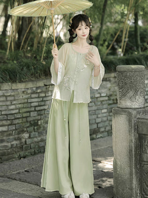 Authentic modern hanfu set white wide sleeve top sage green wide leg pants casual everyday chinese style for women standing front