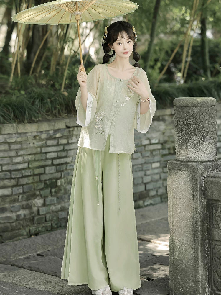 Authentic modern hanfu set white wide sleeve top sage green wide leg pants casual everyday chinese style for women standing front