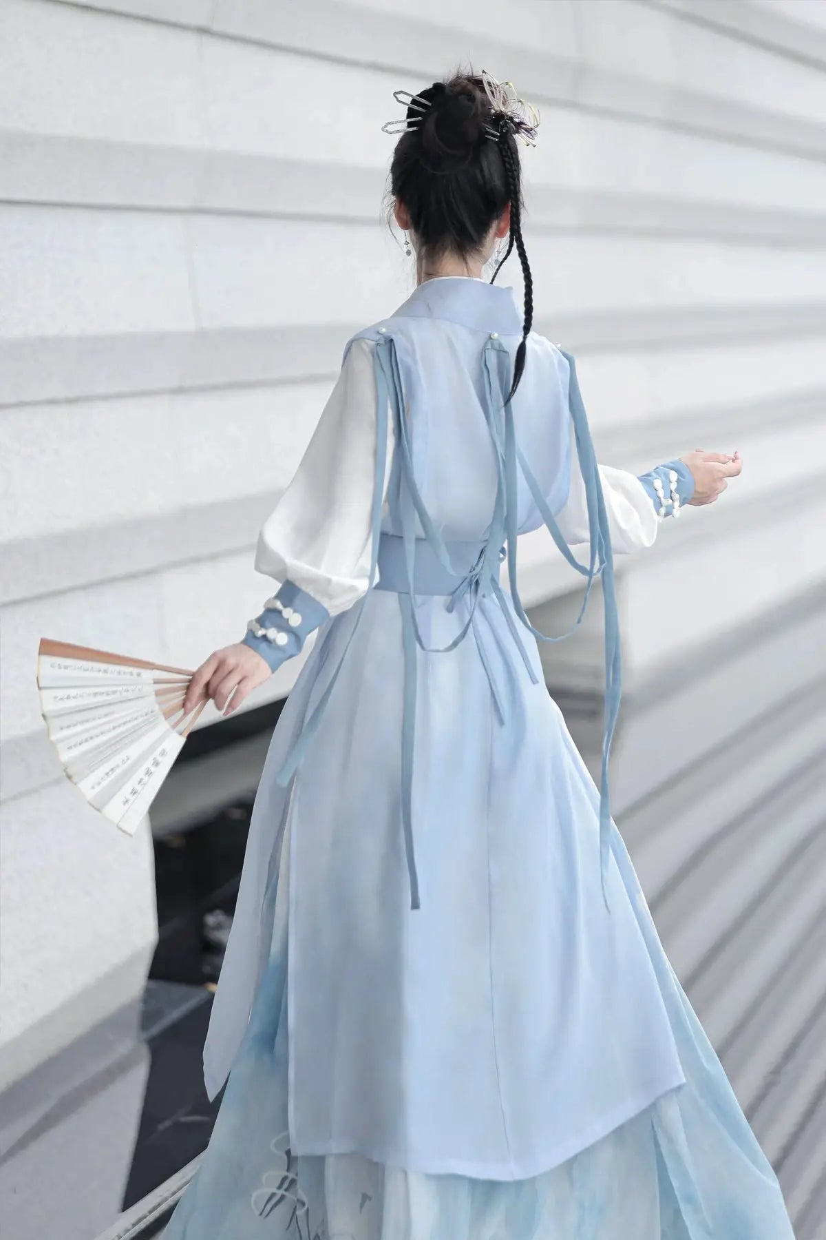 Blue hanfu dress for women, blending traditional Song Dynasty and modern Chinese styles, crafted from luxurious silk. This versatile hanfu includes options for a matching coat or jacket, making it suitable for winter wear, Chinese New Year celebrations, or casual outings. Ideal for occasions like graduations or cosplay, this dress embodies the fairy-inspired elegance of classic hanfu while also drawing from martial arts clothing and contemporary Chinese fashion. Available for purchase in our online hanfu sh