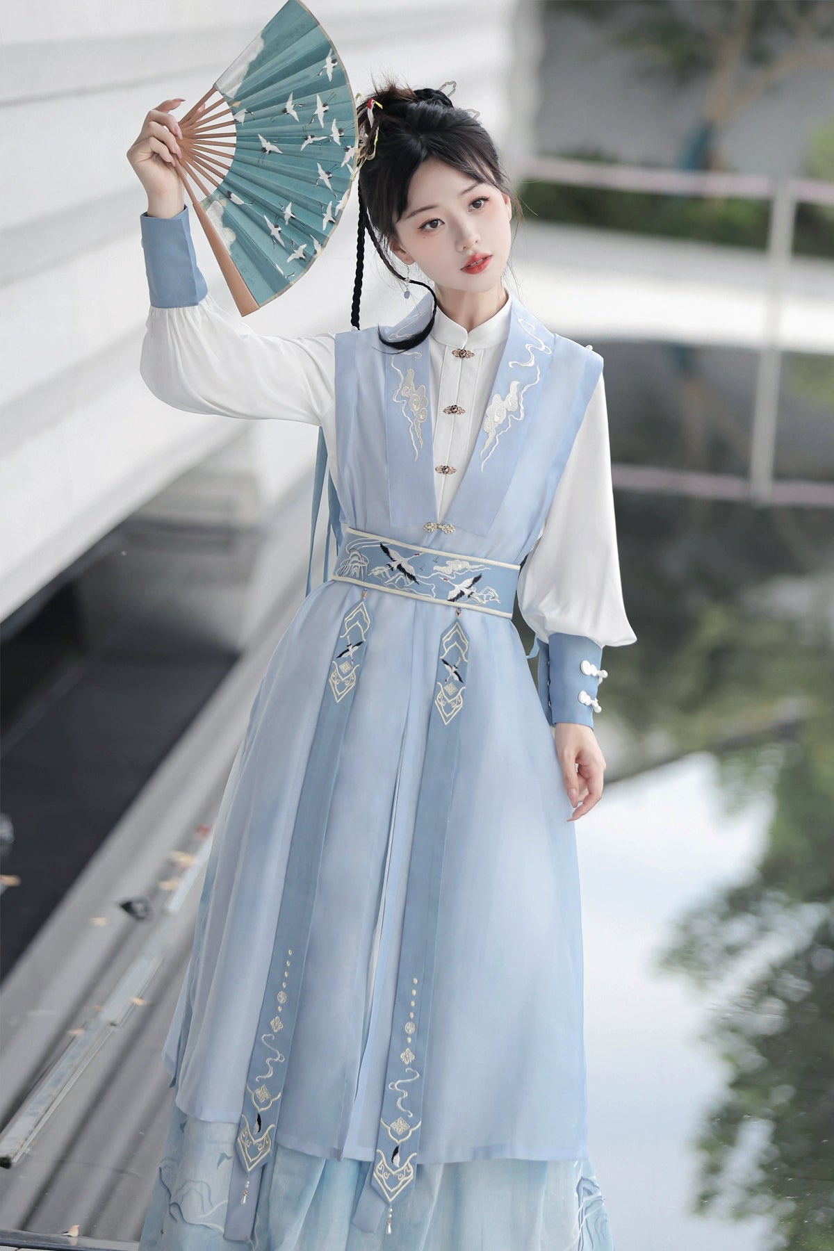 Blue hanfu dress for women, blending traditional Song Dynasty and modern Chinese styles, crafted from luxurious silk. This versatile hanfu includes options for a matching coat or jacket, making it suitable for winter wear, Chinese New Year celebrations, or casual outings. Ideal for occasions like graduations or cosplay, this dress embodies the fairy-inspired elegance of classic hanfu while also drawing from martial arts clothing and contemporary Chinese fashion. Available for purchase in our online hanfu sh