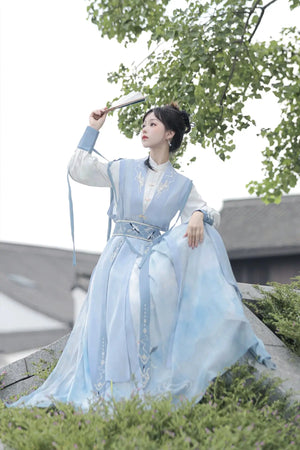 Blue hanfu dress for women, blending traditional Song Dynasty and modern Chinese styles, crafted from luxurious silk. This versatile hanfu includes options for a matching coat or jacket, making it suitable for winter wear, Chinese New Year celebrations, or casual outings. Ideal for occasions like graduations or cosplay, this dress embodies the fairy-inspired elegance of classic hanfu while also drawing from martial arts clothing and contemporary Chinese fashion. Available for purchase in our online hanfu sh