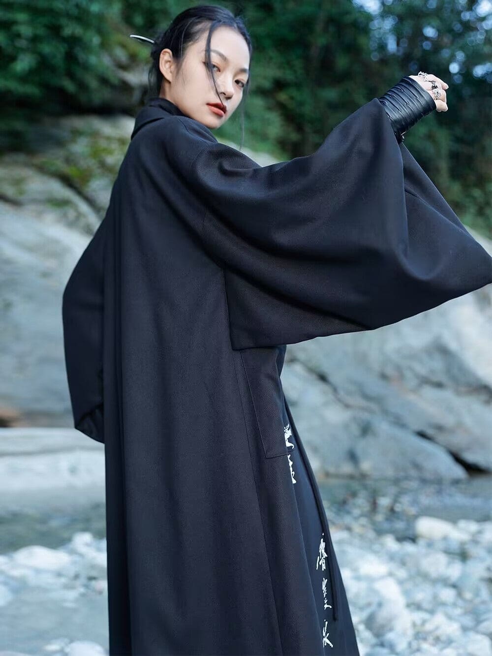 Modern Chinese clothes featuring a black hanfu coat for men, a blend of traditional hanfu menswear and Tang dynasty clothing with a modernized hanfu style, suitable for casual wear or winter hanfu style. The male model is also wearing Chinese cloak and hanfu with pants, depicting a Chinese warrior outfit. The photo indicates where to buy hanfu, including hanfu Amazon and oriental clothing stores near you