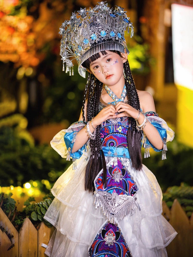 Girls' ethnic style stage costume in Miao Purple with silver accessories and traditional embroidery for Chinese cultural performances.