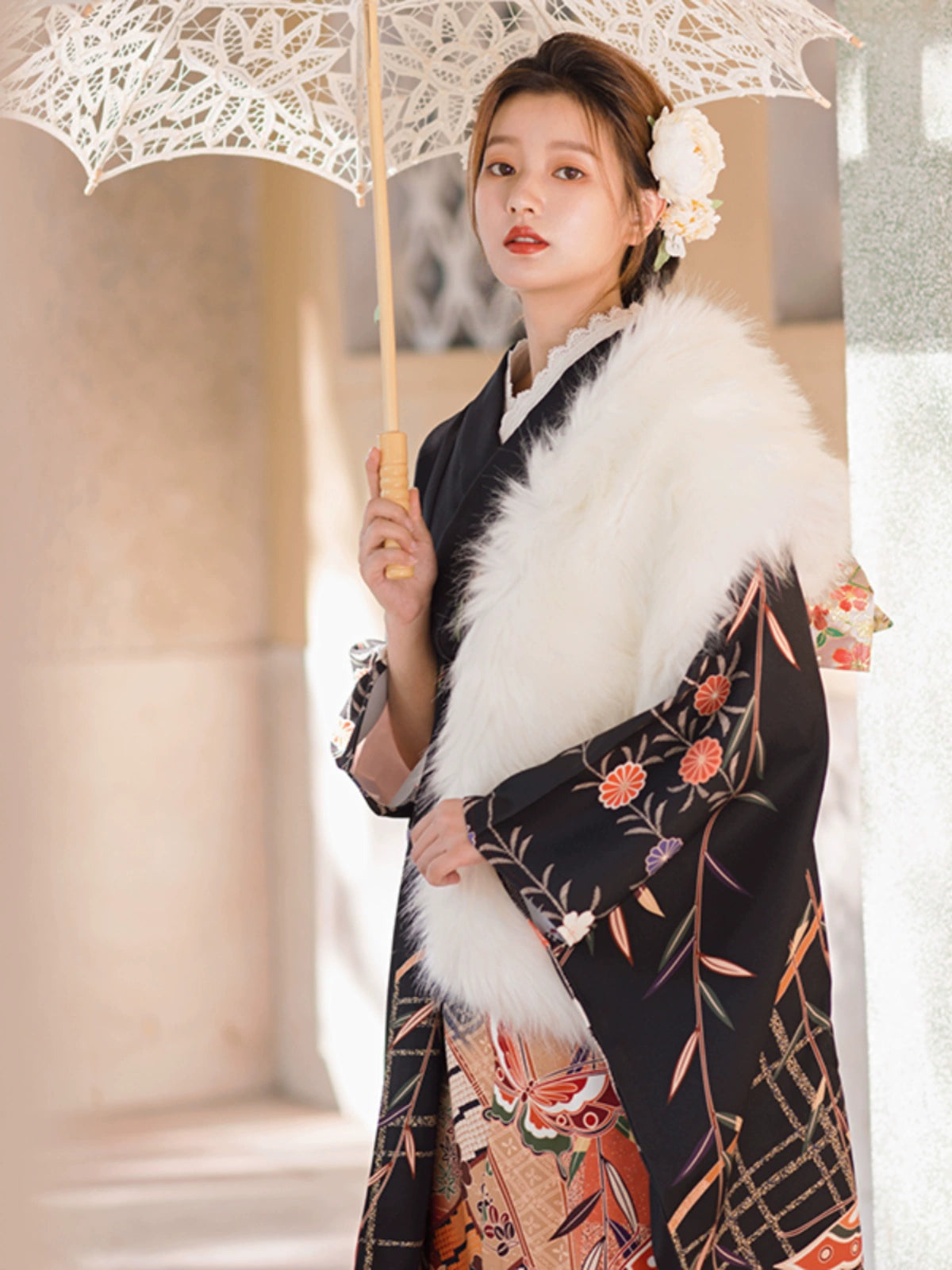 Black kimono with floral motifs and white fur shawl, exuding vintage charm.