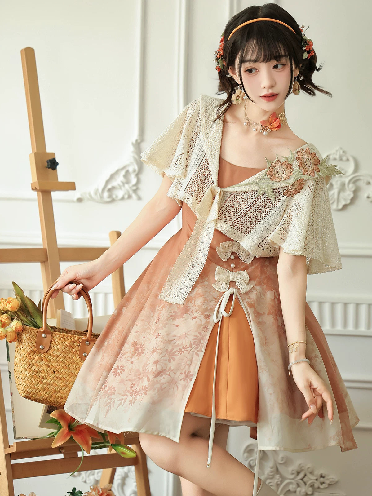 Front view of the peach dress and floral applique capelet