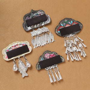 Back view of Guizhou Miao fridge magnets showing magnetic strips and embroidered bases, ideal for cultural refrigerator decoration.