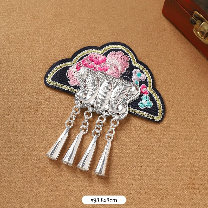 Black embroidered Guizhou Miao fridge magnet with butterfly and silver cone fringe, 8.8x8cm, handmade ethnic accessory.