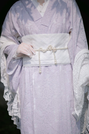 Close-up of a purple lace kimono with a pearl-adorned obi belt.