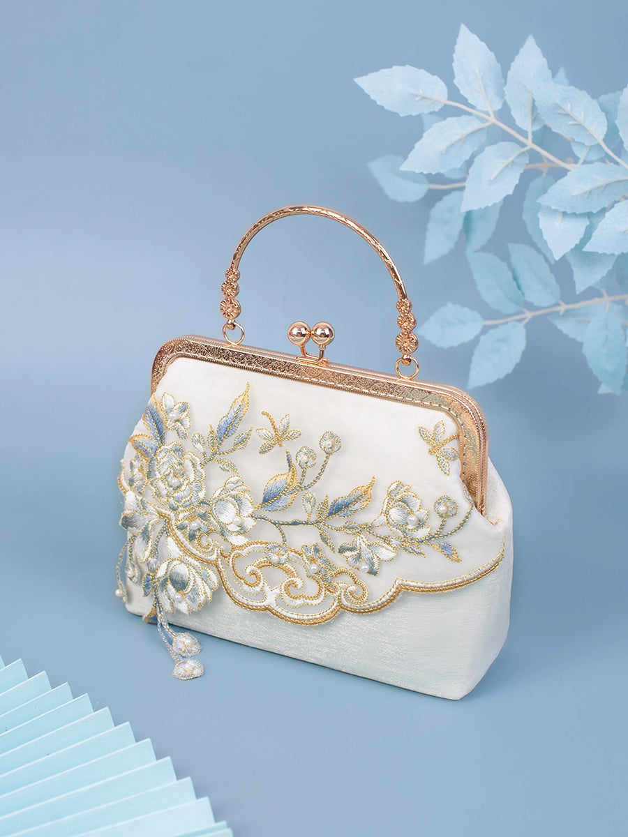 Yuejian Hanfu bag in white with intricate floral embroidery, gold-tone frame, and elegant handle, perfect for traditional attire.