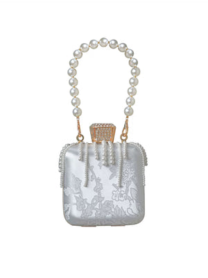 White satin handbag displayed separately on a white background