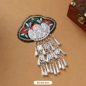 Guizhou Miao fridge magnet with red floral embroidery and long silver fringe, 13x8.3cm, handmade ethnic kitchen decor.