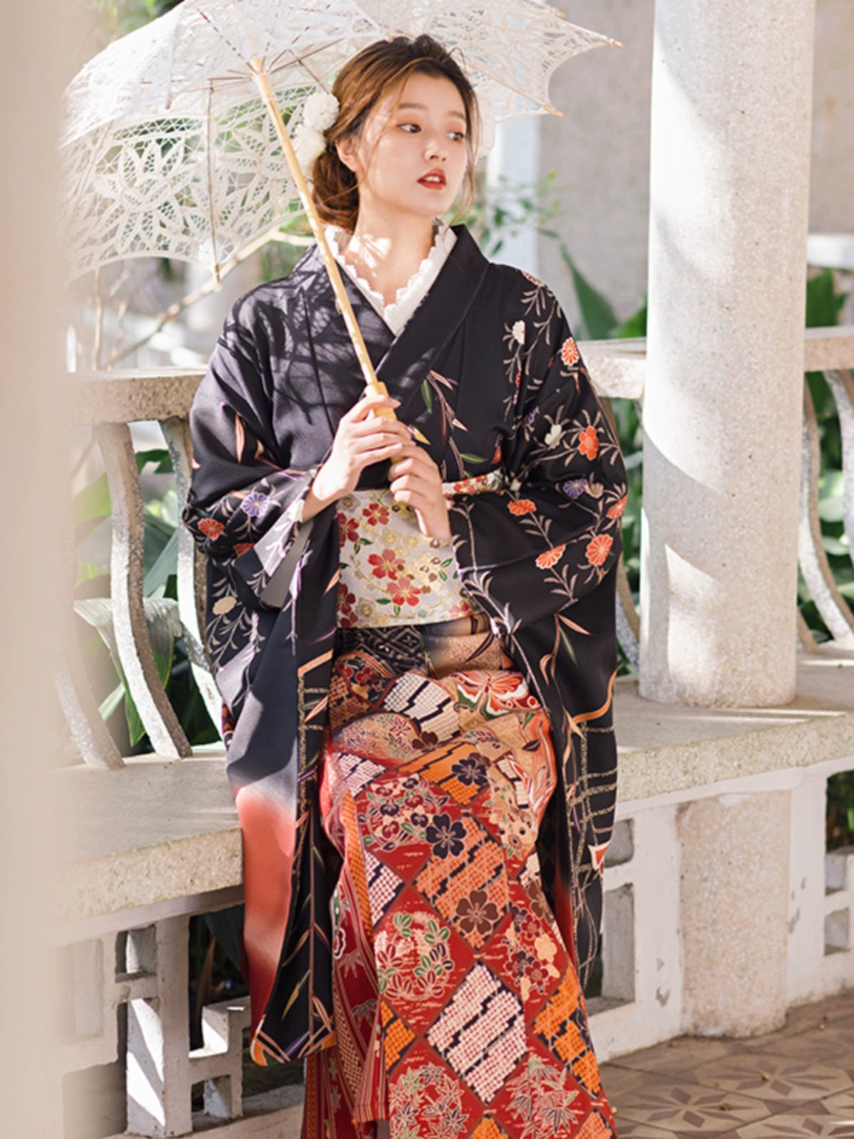 Elegant black butterfly kimono with floral patterns, paired with a lace parasol.