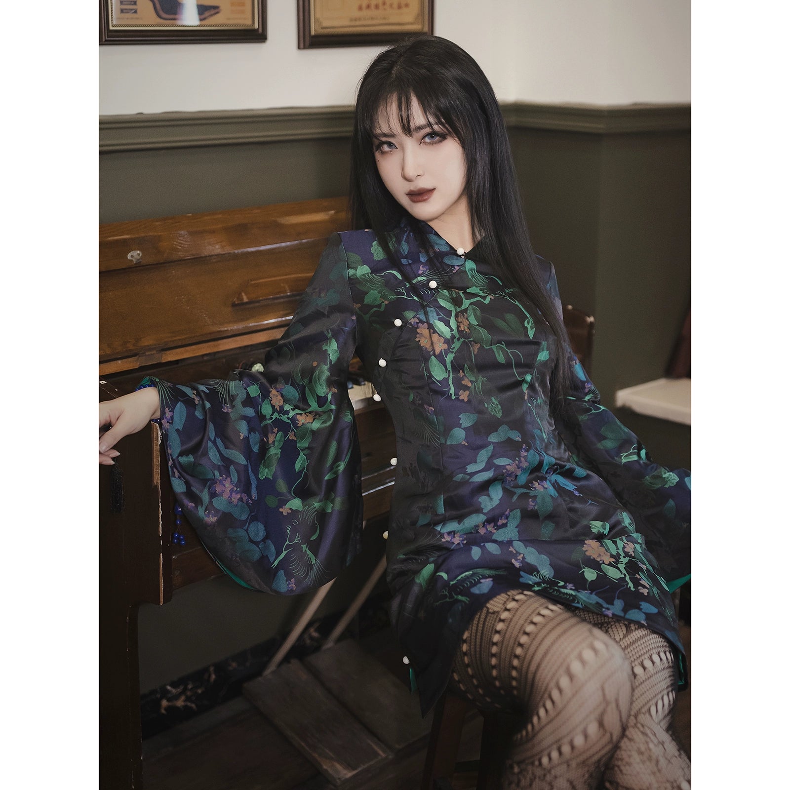 Retro black cheongsam short skirt with green floral jacquard design, bell sleeves, and a fitted silhouette. Perfect for vintage-inspired looks.