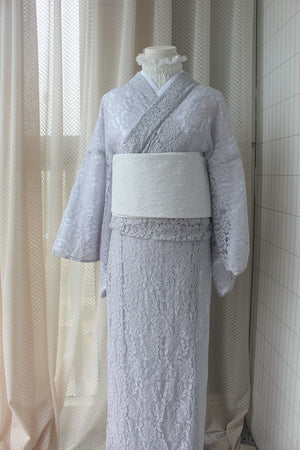 Mannequin displaying a purple lace kimono with a white obi belt.