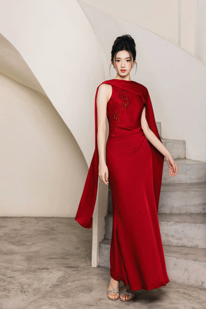 Full-length red Cynthia and Dahlia evening gown with draped shoulder panels