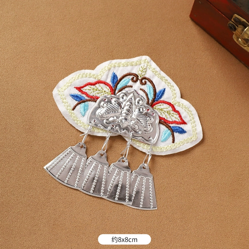 White embroidered Guizhou Miao fridge magnet with silver fan-shaped fringe, 8x8cm, handmade ethnic refrigerator decor.