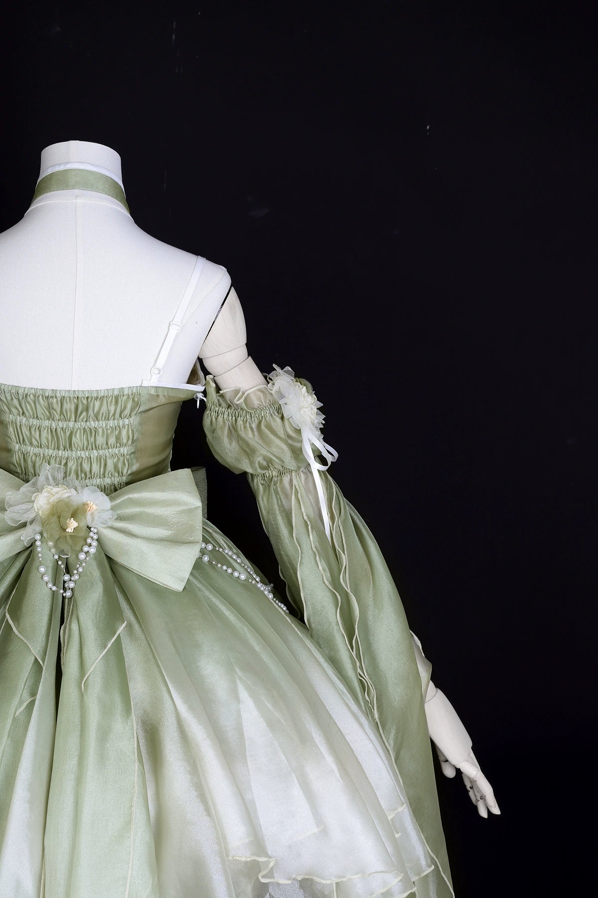Close-up of back bodice and sleeve detail on Green Lolita Dress, showcasing delicate fabric and floral embellishments.