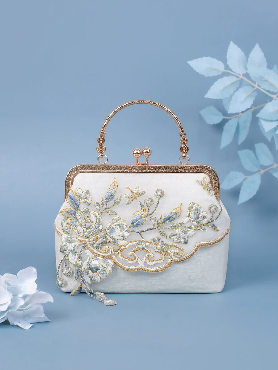 White Yuejian embroidered cheongsam Hanfu bag featuring delicate floral patterns, gold accents, and a vintage clasp design.