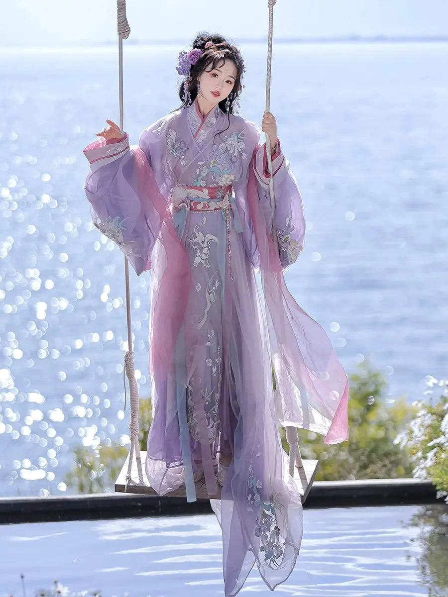 Woman in purple Hanfu on swing by the sea