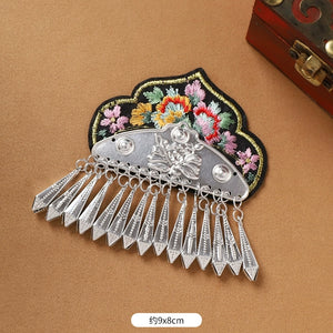 Black floral Guizhou Miao fridge magnet with silver arrowhead fringe, 9x8cm, handmade ethnic refrigerator decor.