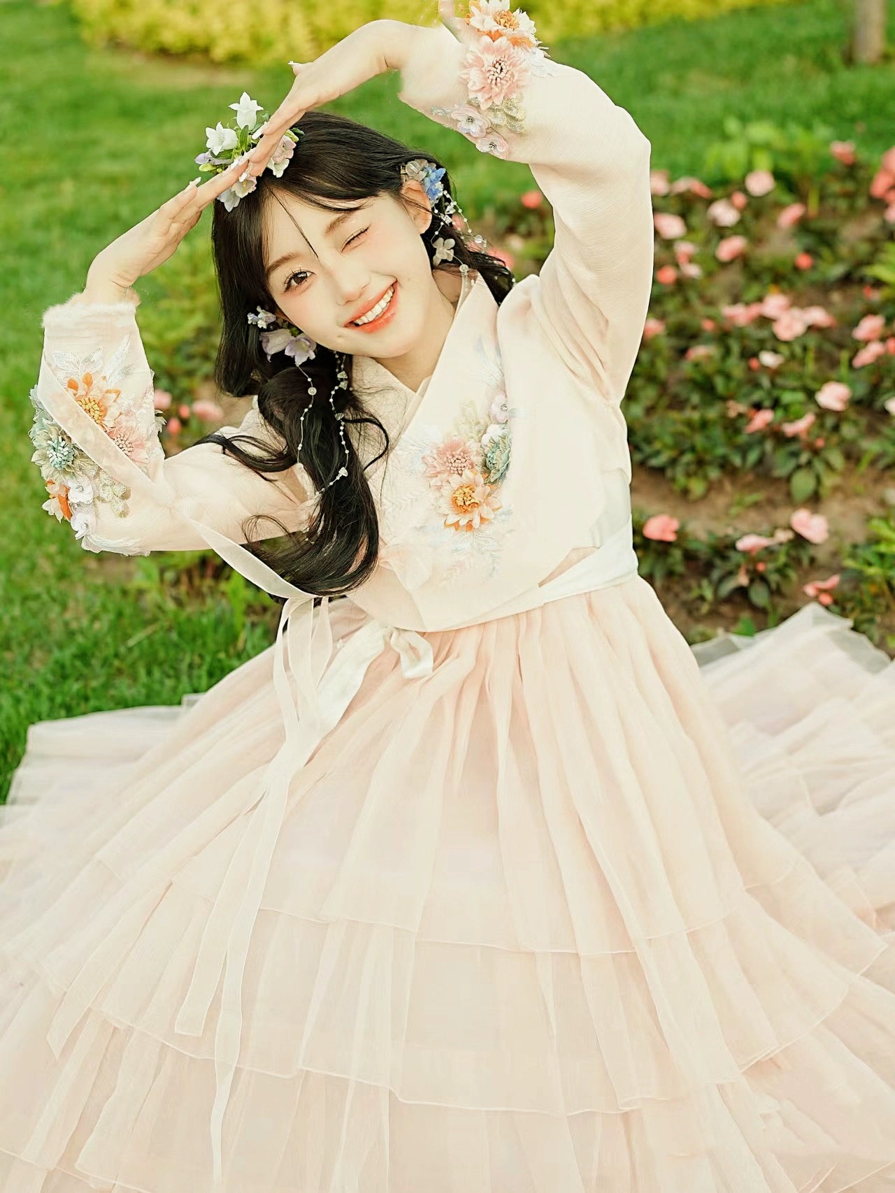 Charming pink Korean Yanji dress featuring intricate floral details and a flowing design.