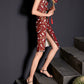 Red cheongsam with crane print and side slit, styled with a traditional fan.