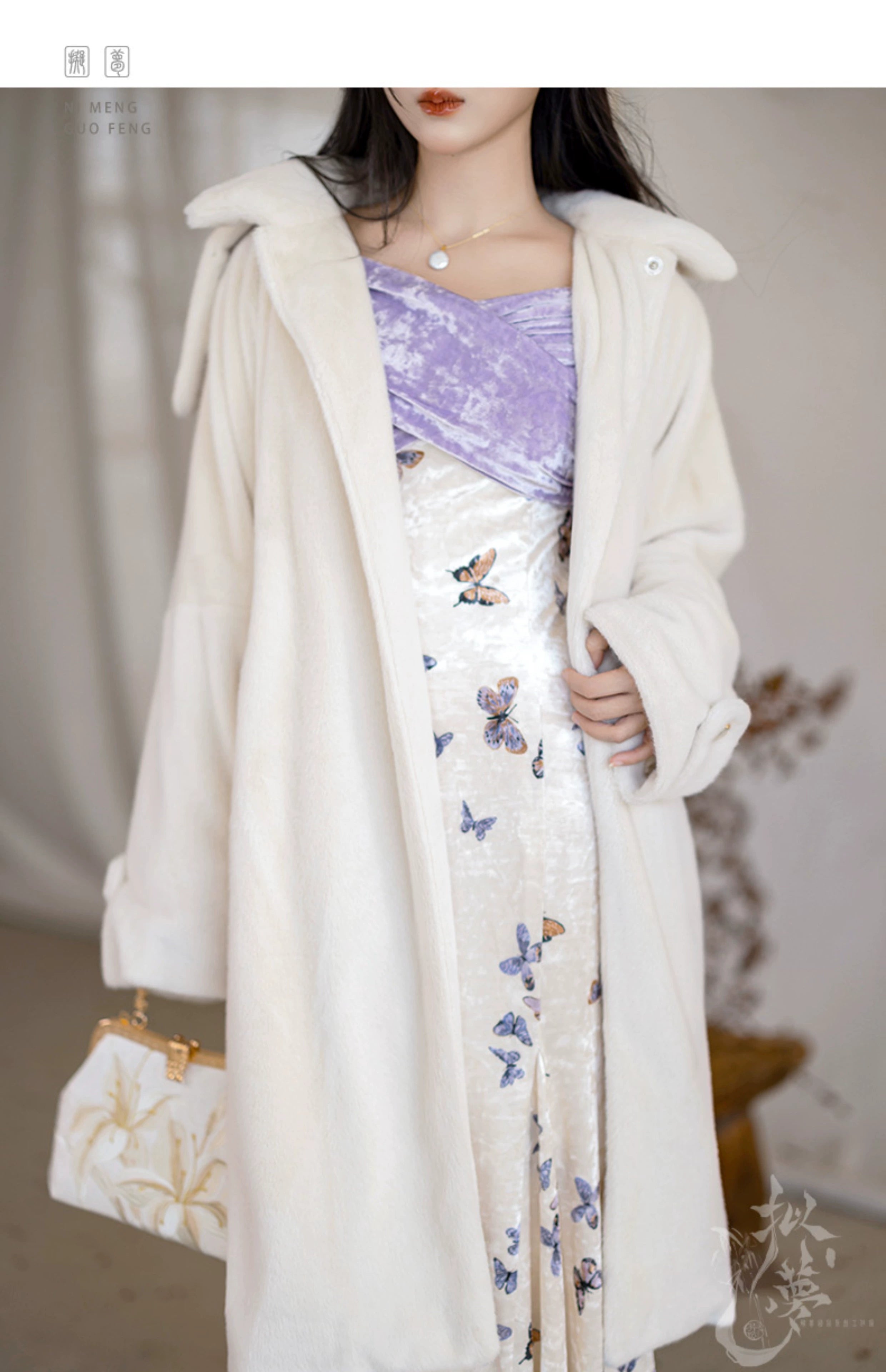 White eco-friendly fur jacket styled over a purple velvet bodice and butterfly-printed fishtail skirt, perfect for winter.