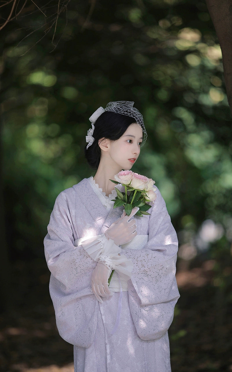 Purple lace kimono with gloves and roses in a natural outdoor setting.