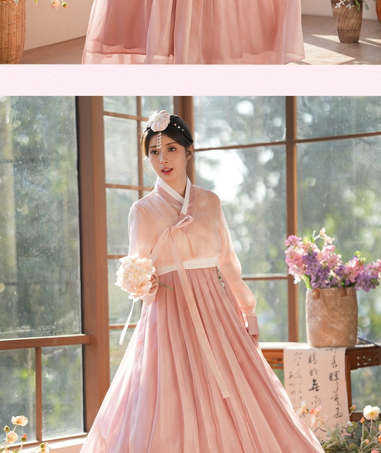 Flowing pink hanbok dress with elegant draping and a traditional Korean aesthetic. Ideal for cultural events and formal occasions.