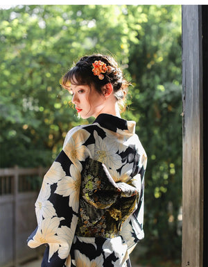 Rear view of a Japanese kimono dress with a floral design and intricate obi belt, styled for traditional festivals and events.