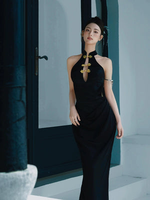 Classic black fishtail cheongsam dress with a halter neckline and gold floral embellishments, styled for a modern look.