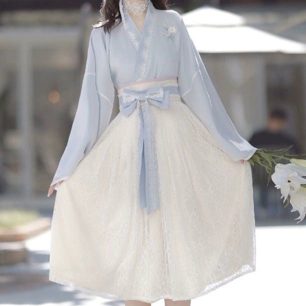 Front view of Blue Modern Hanfu Dress with floral lace skirt and ribbon belt, perfect for spring fashion and cultural events.