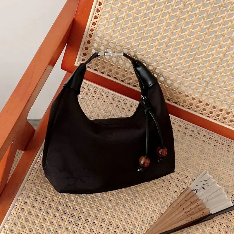 Silk cheongsam handbag with embroidered details for qipao and hanfu outfits.