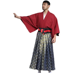 Man showcasing a Japanese traditional kimono with wide red sleeves and a detailed brocade skirt, posing against a white background.