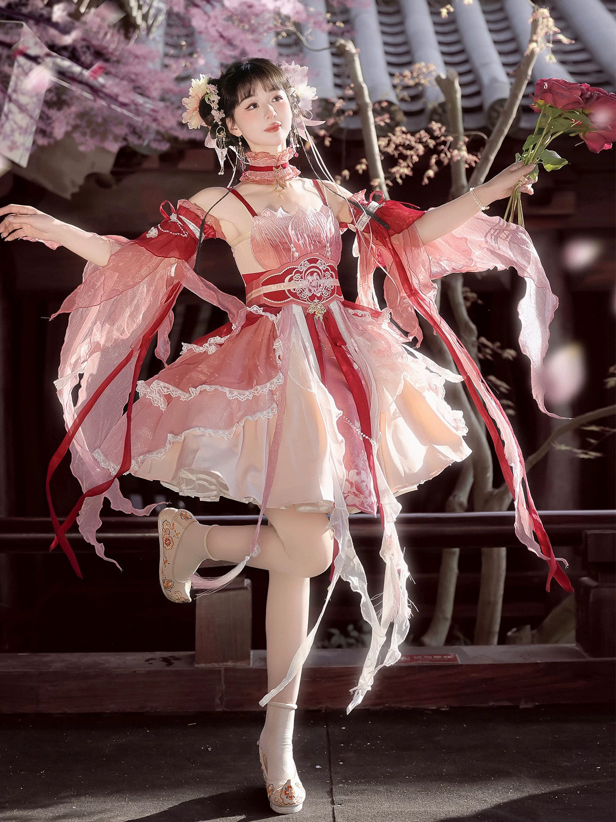 Model dancing in Red Hanfu Dress New Chinese Feather Rust Waist Seal Suspender Skirt with floral hairpiece and embroidered bodice.