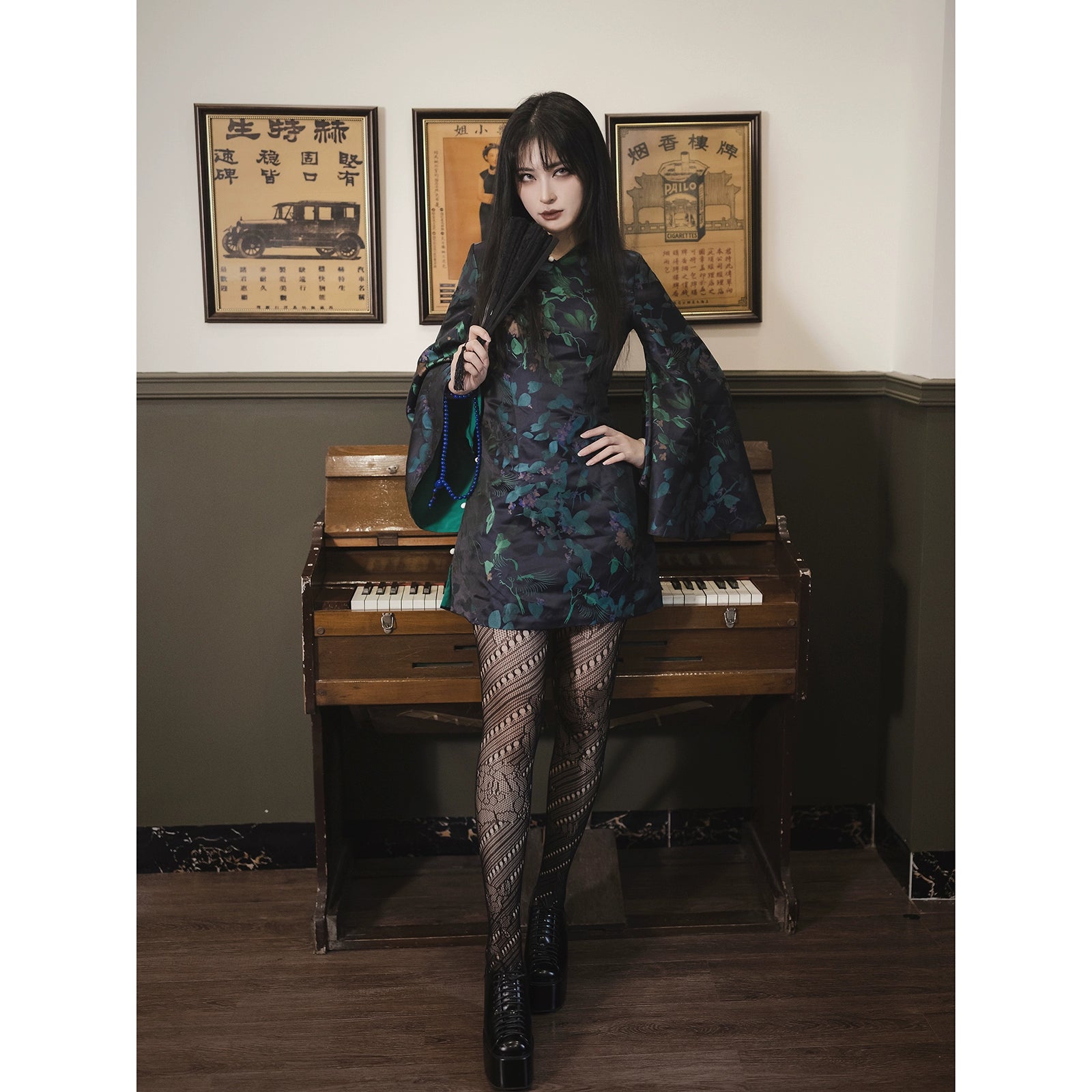 Elegant black and green cheongsam short skirt with bell sleeves and floral jacquard brocade. Designed with a glossy finish and fitted cut.