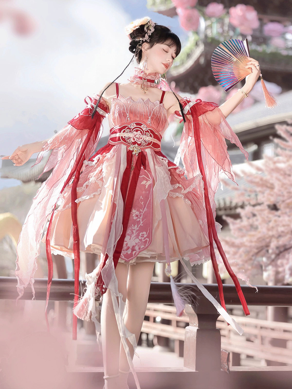 Model holding fan in Red Hanfu Dress New Chinese Feather Rust Waist Seal Suspender Skirt with floral motifs and flowing sleeves.
