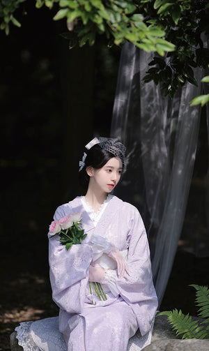 Purple lace kimono styled with roses and a delicate veil backdrop.