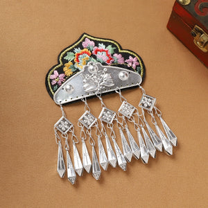 Black embroidered Guizhou Miao fridge magnet with silver diamond-shaped fringe, handmade ethnic kitchen ornament.