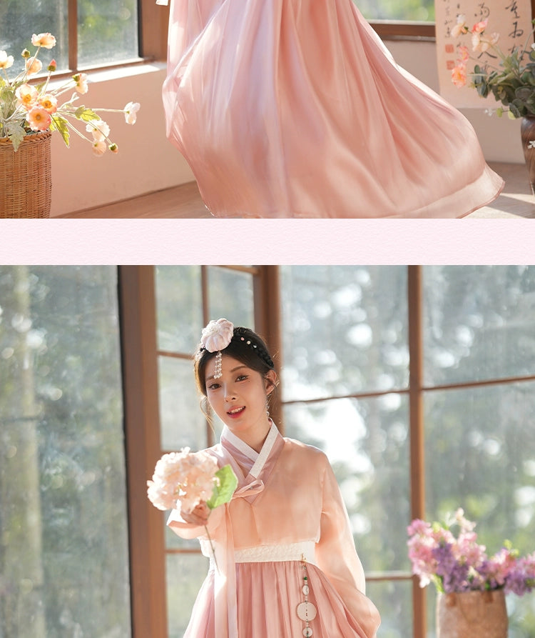 Graceful hanbok dress in a lotus root pink shade, featuring a classic Korean silhouette. A timeless and elegant choice.