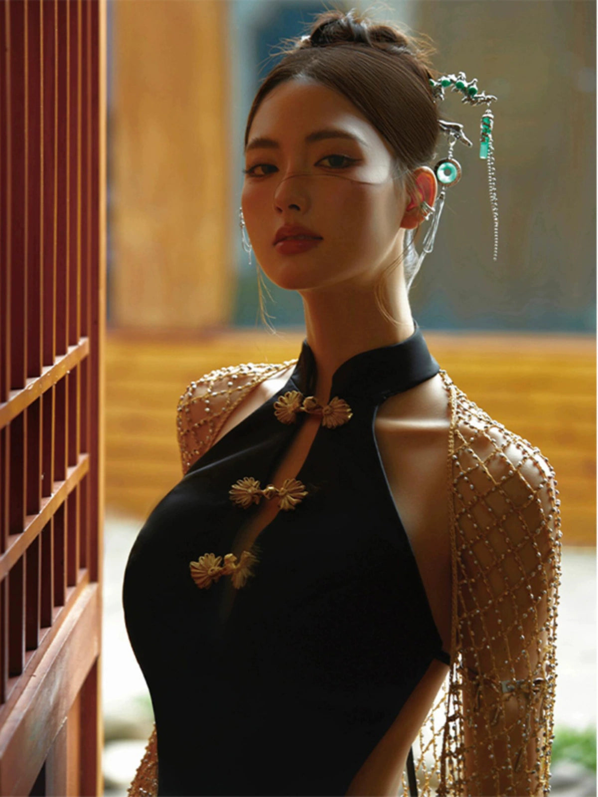 Black retro cheongsam fishtail dress with gold floral accents, styled with a chic updo and elegant accessories.